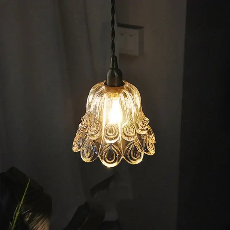 Ornate amber copper led pendant light with peacock feather design and black twisted cord for café and dining room