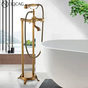 Ornate antique brass freestanding bathtub filler with handshower featuring intricate detailing for freestanding bathtubs