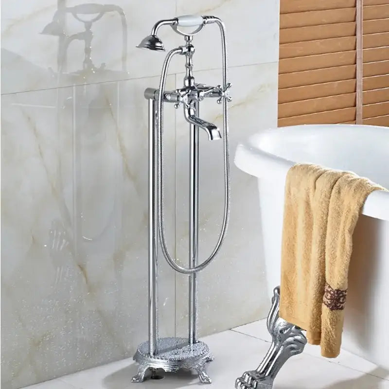 Chrome-finished vintage-style freestanding bathtub filler with ornate claw-foot base and detachable handheld showerhead