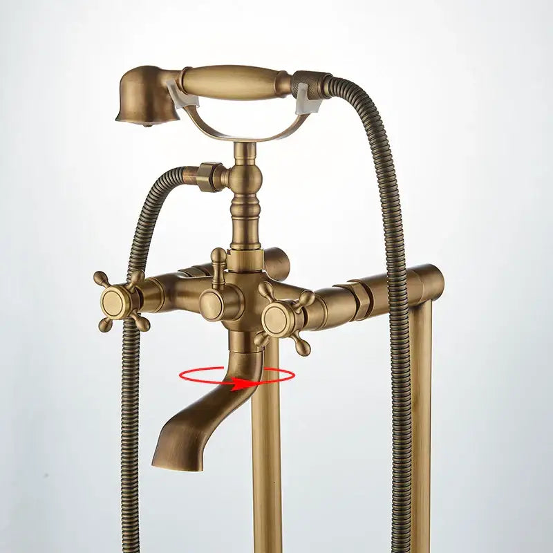 Ornate antique brass freestanding bathtub filler with clawfoot tub faucet cross handles and flexible shower hose