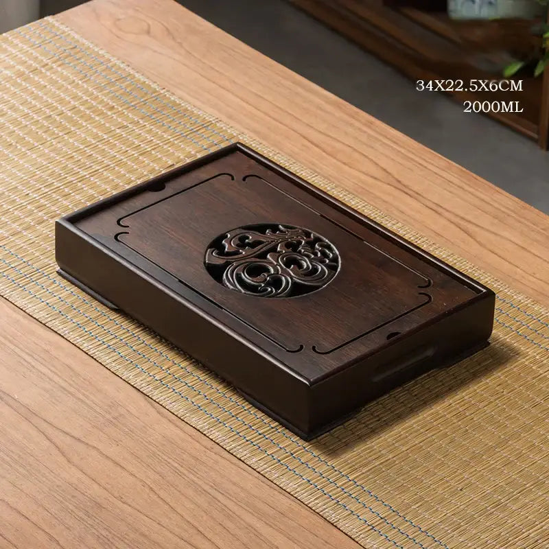 Dark brown wooden tea tray with intricate carved floral design for ornate black bamboo tea tray drainage use