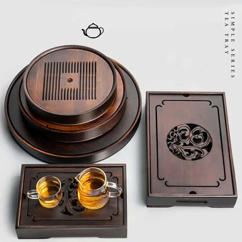 Ornate black bamboo tea tray with intricate carvings and circular drainage slits for dining room water storage