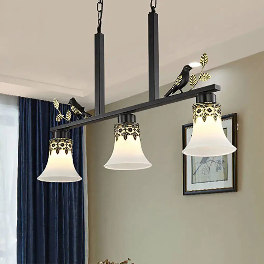 DecorBites classic black island pendant light with three frosted glass shades and gold leaf bird motifs