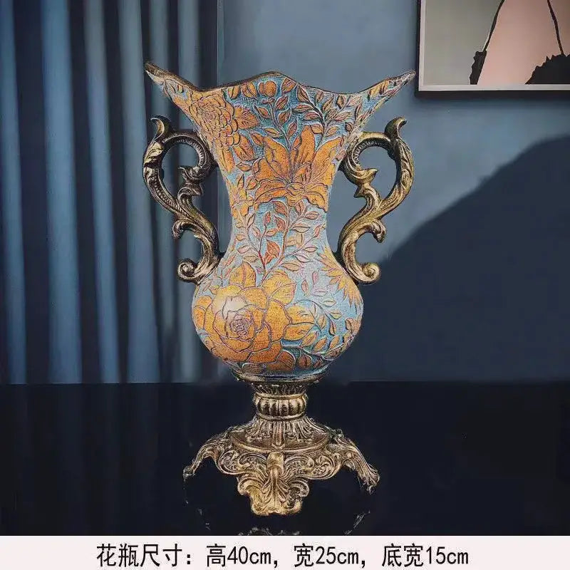 Antique-style resin vase dried with ornate gold handles and floral patterns in gold on muted blue for living room decor