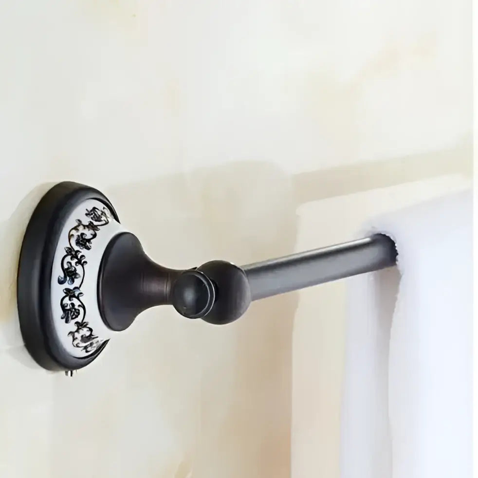 Antique bronze wrought iron towel rack with decorative white ceramic base featuring black floral patterns bathroom accessories set