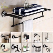 Ornate black wrought iron towel rack with white patterned circular mounting plate in bathroom accessories set