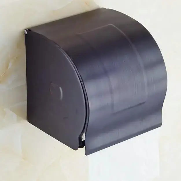 Black plastic toilet paper holder with curved modern design in ornate black and white bathroom accessories set