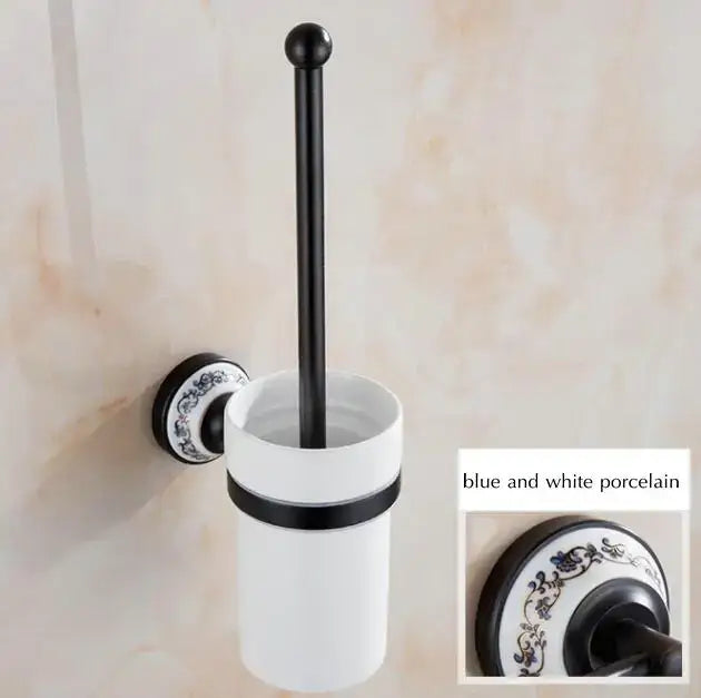 White porcelain toilet brush holder with black metal accents and blue and white patterns in bathroom accessories set