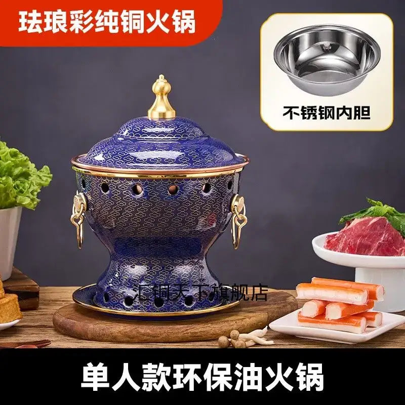 Ornate blue and white enamel copper hot pot with deep blue enamel coating gold-trimmed handles and stainless steel bowl
