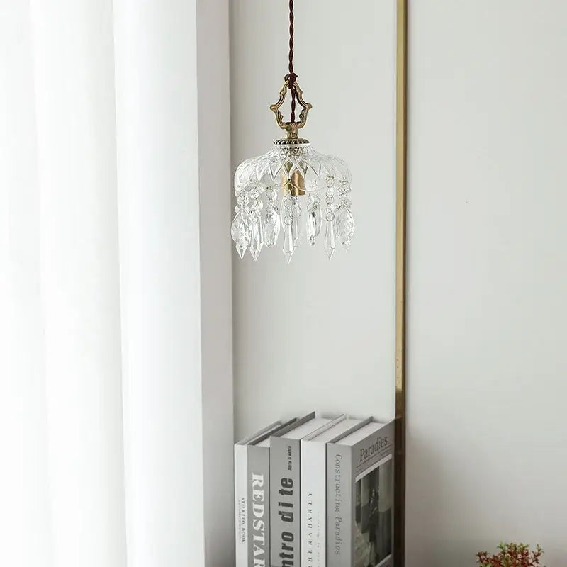 A delicate clear crystal glass led pendant light with brass finish and hanging chain for bedroom decorbites crystal glass