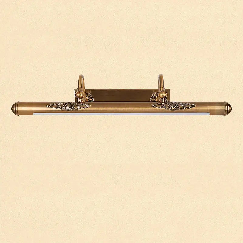 Antique brass bathroom mirror lamp with ornate floral detailing and sleek elongated rectangular design wall mounted