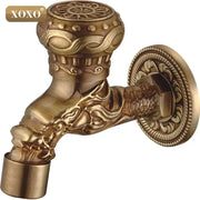Ornate brass faucet tap with intricate xoxo decorbites dragon style head and decorative floral patterns for bathroom mount
