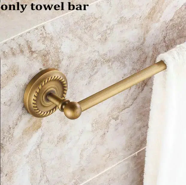 Antique brass towel bar with ornate rope-decorated base and polished spherical end cap in copper bathroom accessories set