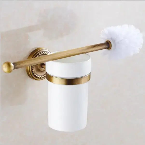 White ceramic toilet brush holder with gold-toned accents and brass-finished rod from ornate copper bathroom accessories set decorbites