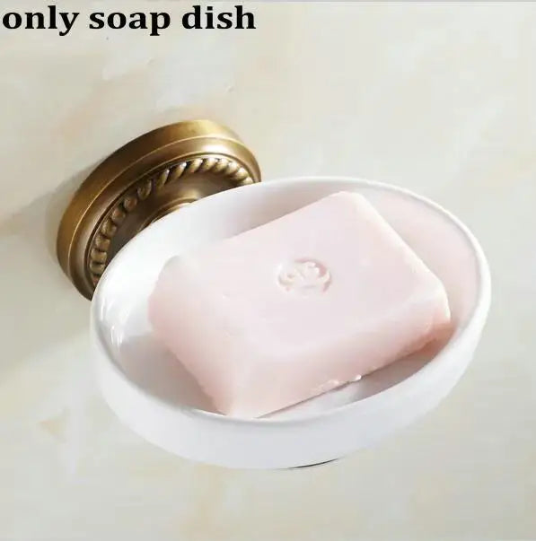 White ceramic soap dish with gold toned copper mounting bracket holding pink soap from decorbites copper bathroom accessories set