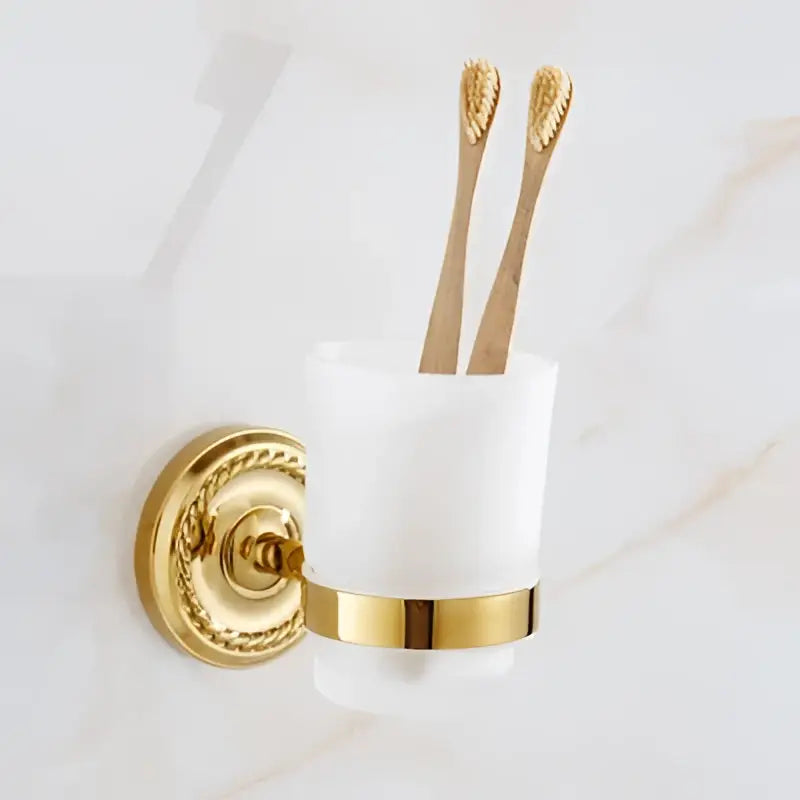 Gold and white ceramic toothbrush holder with ornate brass gold wall mount from decorbites brass gold bathroom hardware set
