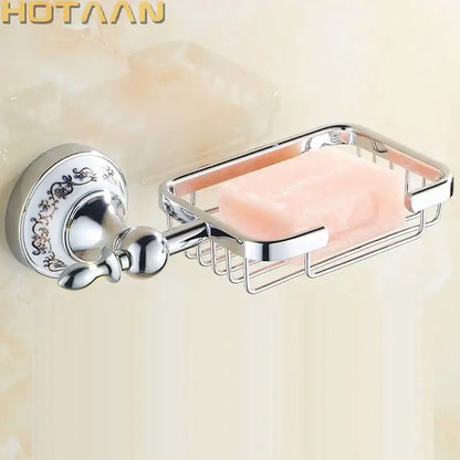 Chrome-finished wall-mounted soap dish with ornate decorative plate and wire mesh basket holding pink soap bar