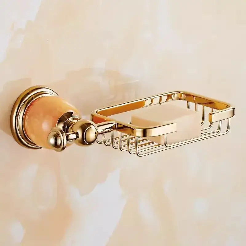 Gold-toned brass jade bathroom soap dish with decorative amber glass knob and wire mesh basket from decorbites brass jade set