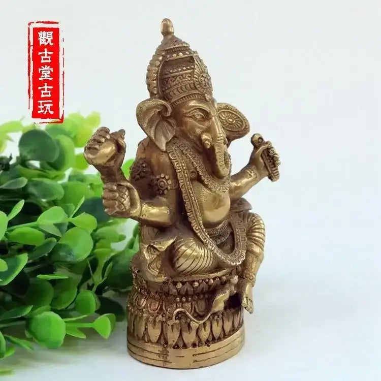 Golden brass ornate bronze ganapati elephant statue with intricate jewelry and crown for living room decor