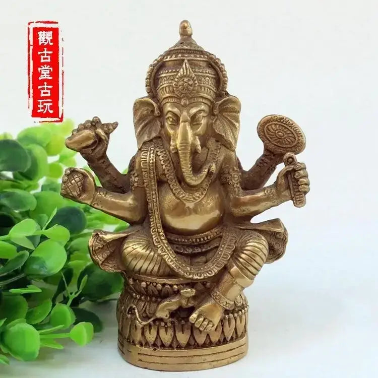 Ornate golden brass bronze ganapati elephant statue with intricate jewelry for living room decor