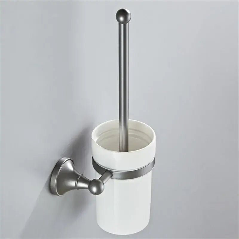 White ceramic toilet brush holder with brushed nickel wall mount and handle in ornate brushed nickel gray bathroom accessories set