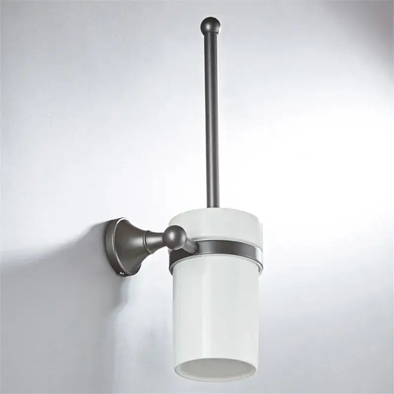 White ceramic toilet brush holder with matte black metal wall mount and handle in ornate brushed nickel gray bathroom accessories set