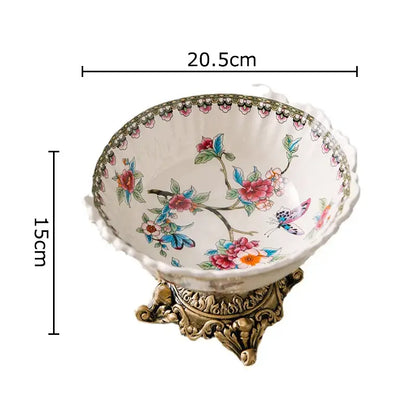 Ornate ceramic pattern fruit bowl with colorful flower pattern and butterfly design on gold metal stand for dining room