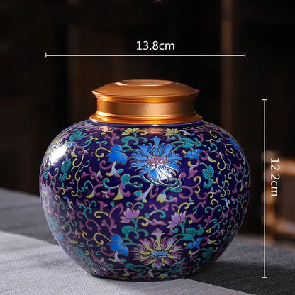 Ornate ceramic storage jar with vibrant blue floral enamel and polished gold lid for tea pot or kitchen use