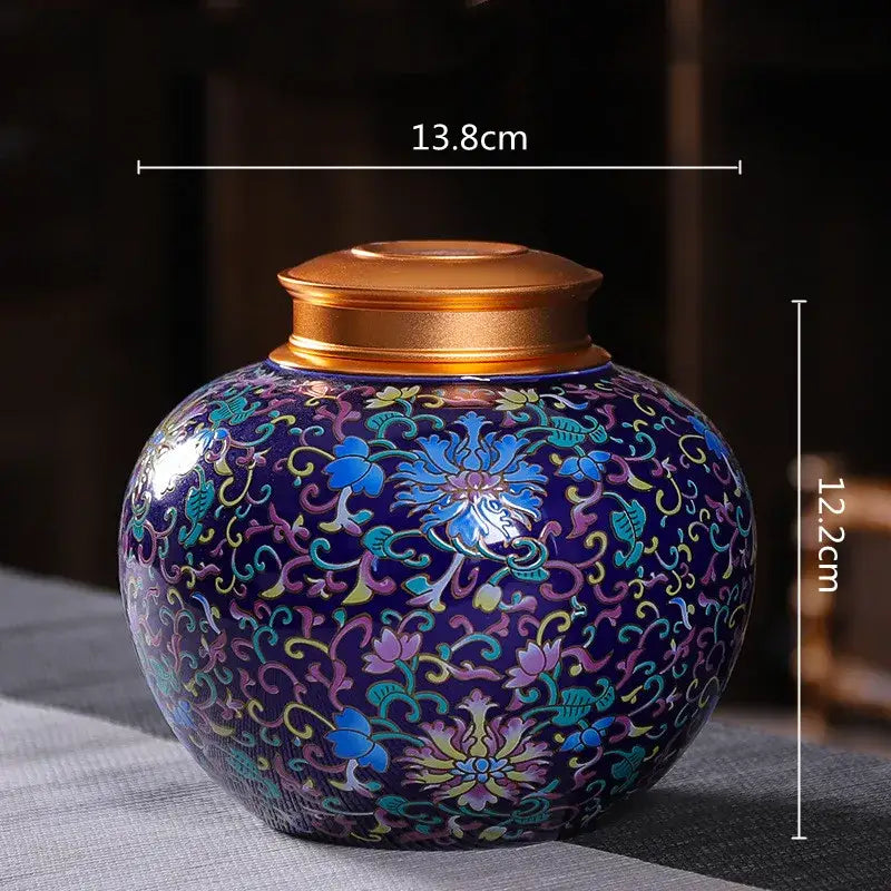Ornate ceramic storage jar with vibrant blue floral enamel and polished gold lid for tea pot or kitchen use