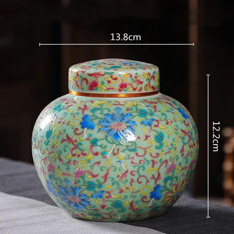 Ornate ceramic storage jar with light green glaze and intricate floral patterns for kitchen tea pot use