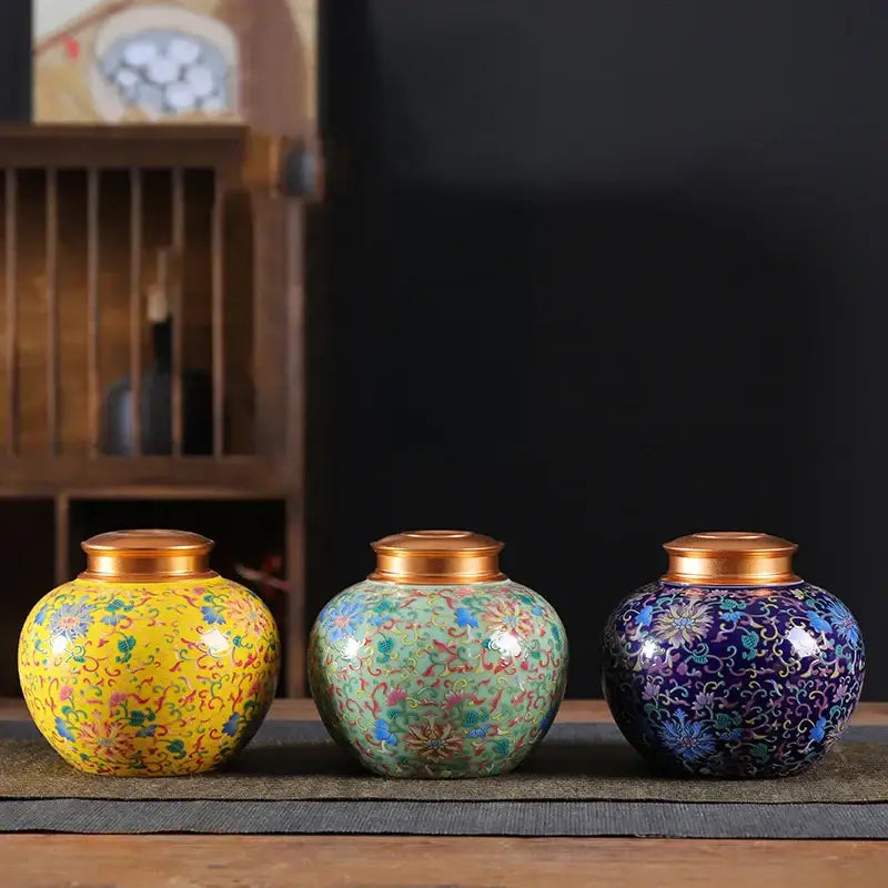 Ornate ceramic storage jar set with vibrant floral patterns and gold lids ideal for kitchen tea pot or coffee storage
