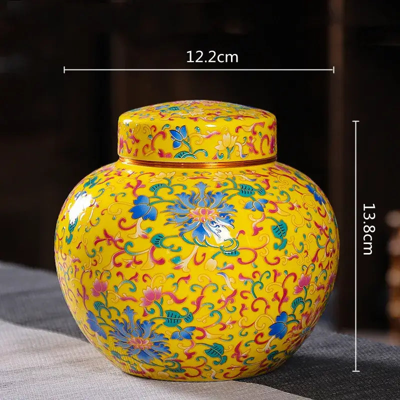 Vibrant yellow ceramic storage jar with intricate blue pink and green floral patterns for tea and coffee storage