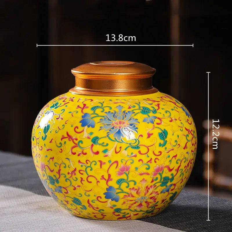 Vibrant yellow ceramic storage jar with intricate floral patterns and golden lid for tea and coffee storage