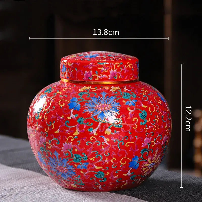 Vibrant red ceramic storage jar with intricate blue green and gold floral patterns for tea and coffee storage