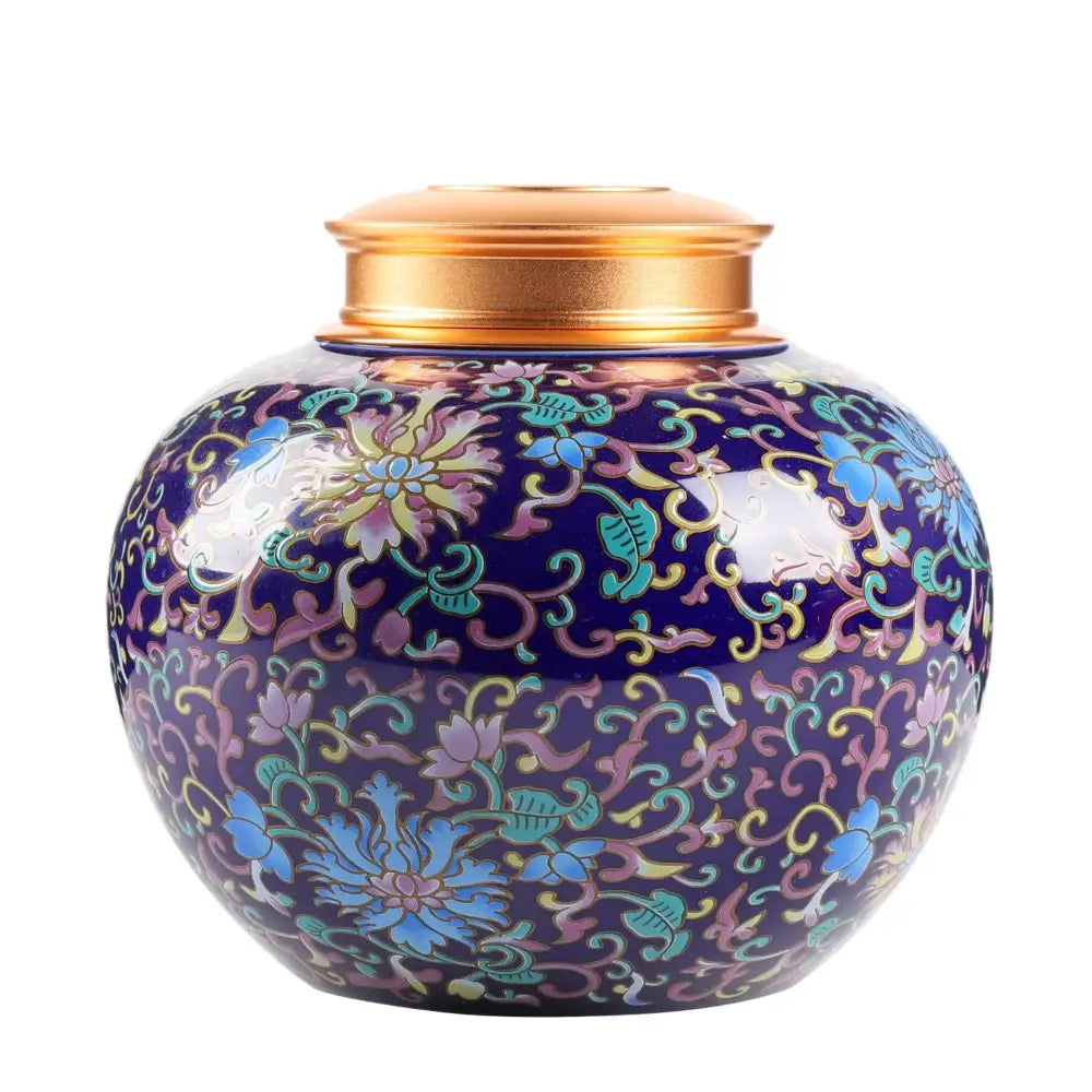 Ornate deep blue ceramic storage jar with multicolored floral patterns and a polished gold lid for tea or coffee storage
