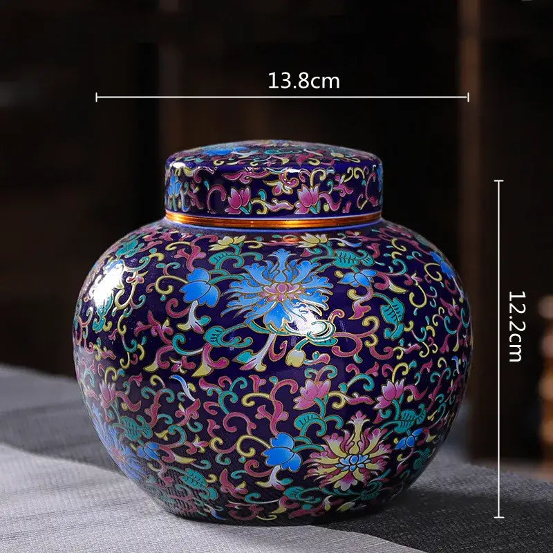 Glossy dark blue ceramic storage jar with ornate colorful floral and vine patterns for tea and coffee storage