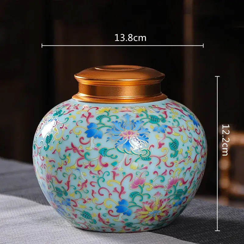 Ornate floral ceramic storage jar with gold-toned lid in vibrant blues and pinks for tea and coffee storage