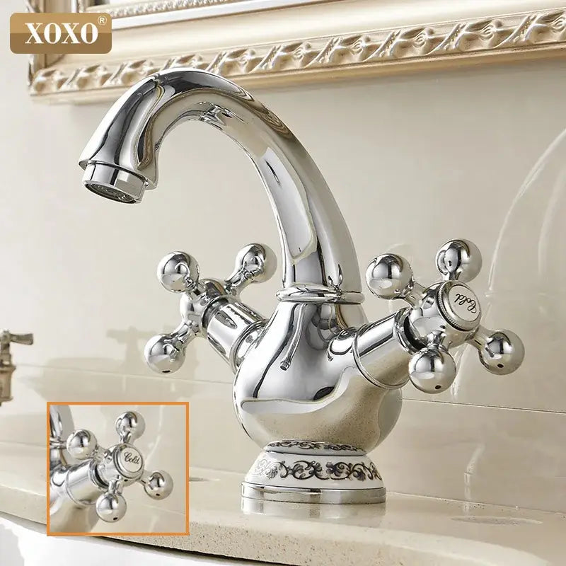 Ornate gold and chrome xoxo brand double handle chrome basin faucet with cross-handle knobs and decorative base
