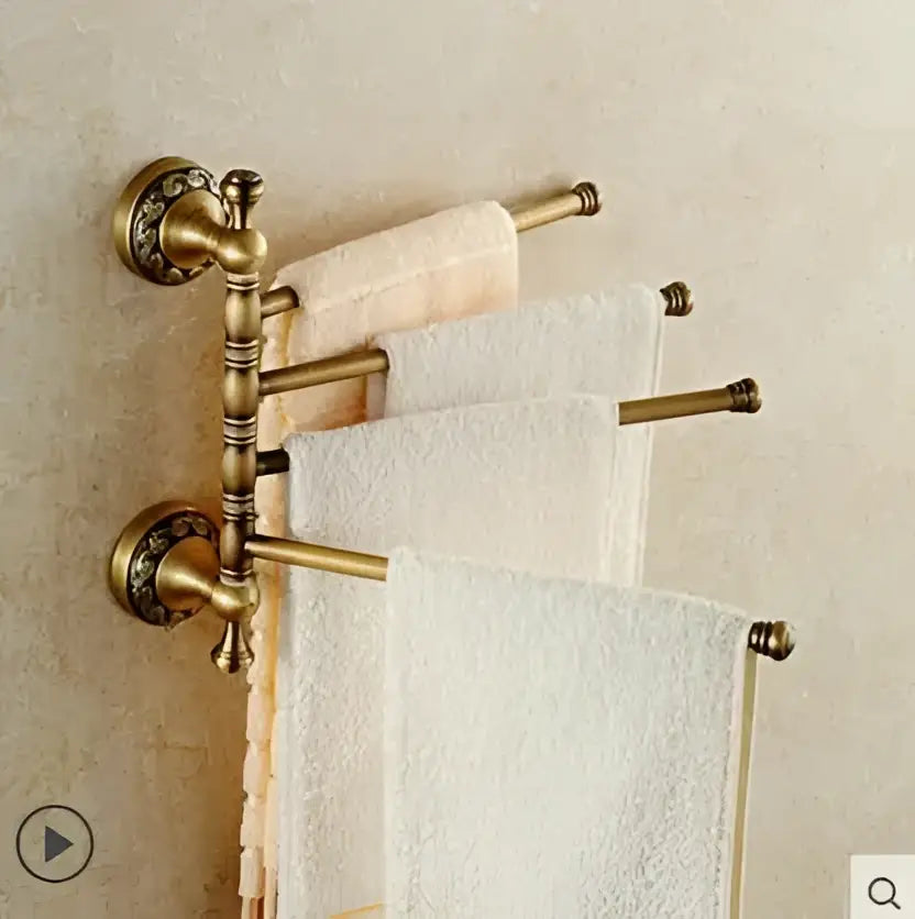 Antique brass double-tier towel rack with ornate detailing holding white towels from decorbites copper carved bathroom set