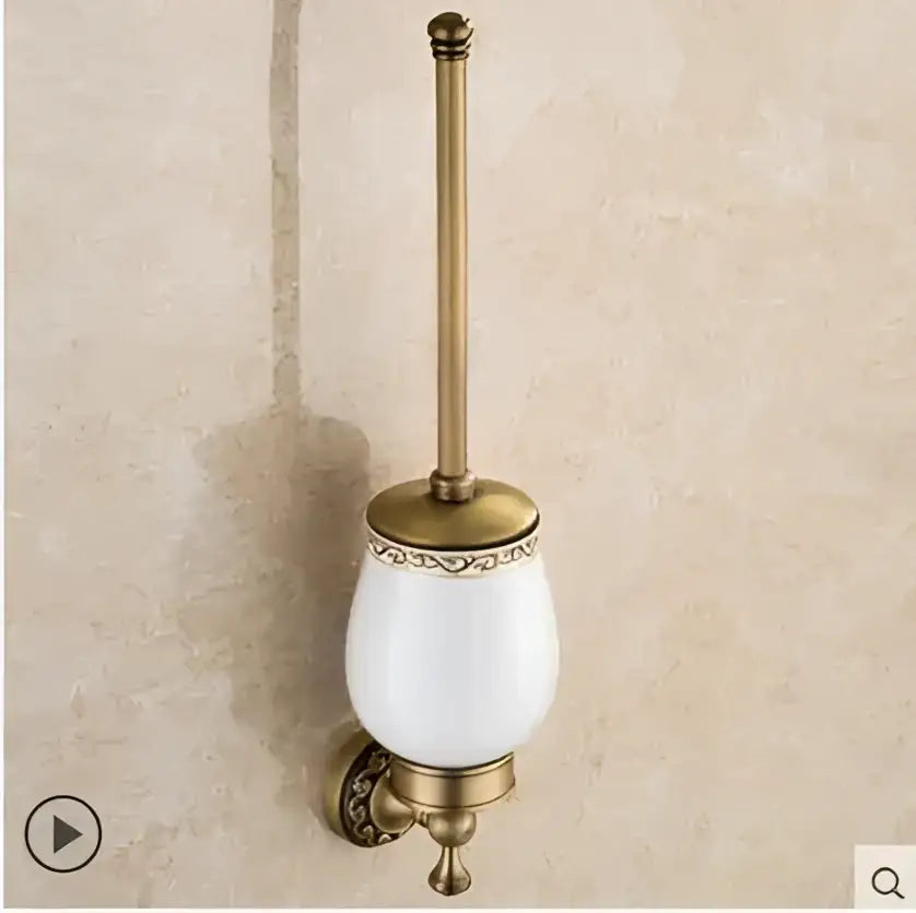 Antique brass toilet brush holder with white ceramic bowl and ornate gold detailing from decorbites copper carved bathroom set