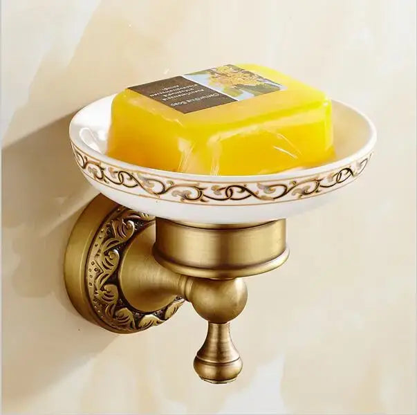 Antique brass wall-mounted soap dish with ornate scrollwork and white ceramic bowl in decorbites copper carved bathroom set