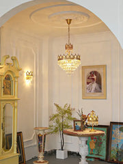 A gold ornate crown crystal led pendant light with crystal droplets for living room decorbites pendant light