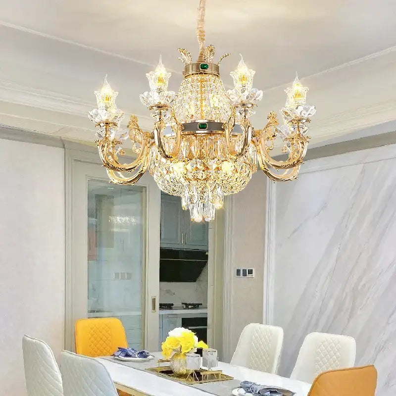 Ornate gold crystal dining room chandelier with green gemstone accents perfect for decorbites crystal dining spaces