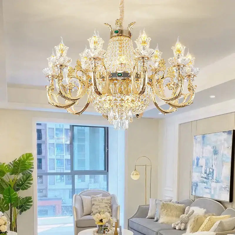 Ornate gold crystal dining room chandelier with clear droplets and central green gemstone for decorbites crystal dining decor
