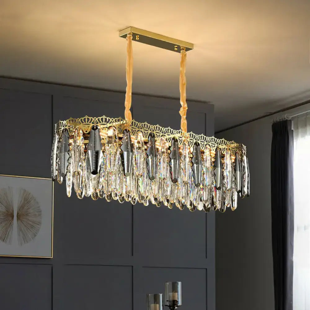 Gold-toned DecorBites™ minimalist crystal leaf pendant light with clear crystal teardrops and ornate fixture width design