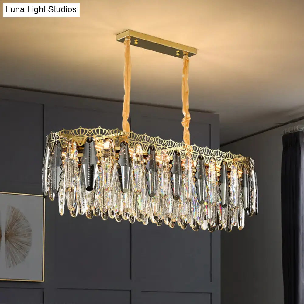 Gold-toned DecorBites™ minimalist crystal leaf pendant light with clear crystal teardrops and ornate crown fixture width