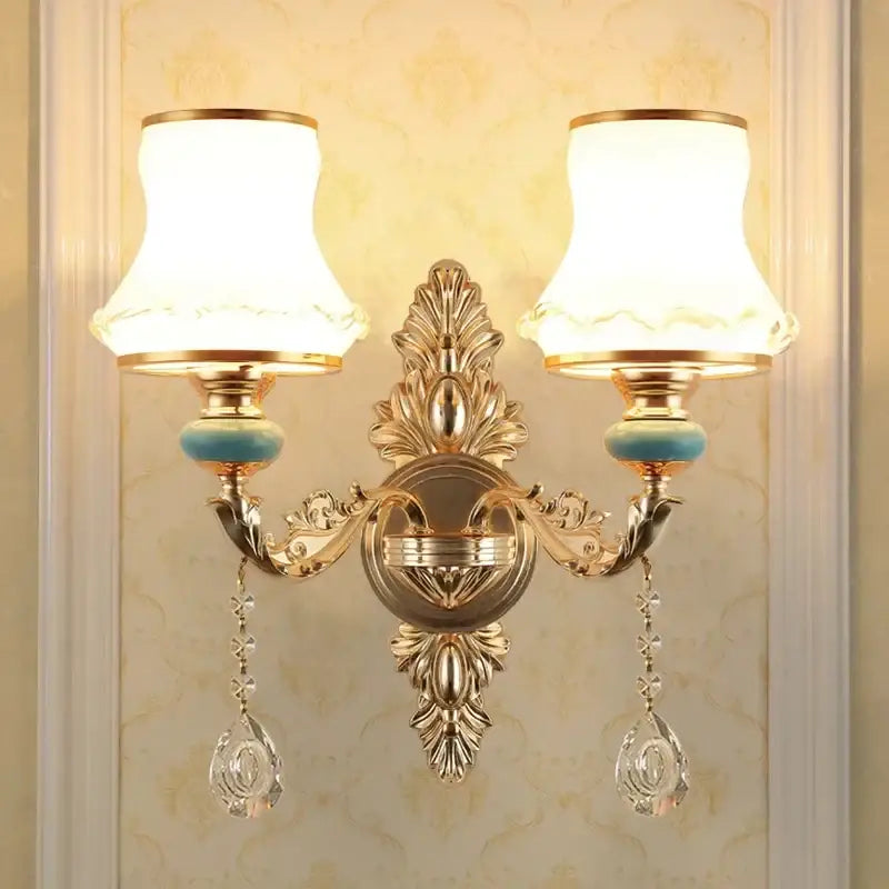 Ornate gold crystal wall sconce with two frosted shades and dangling teardrop pendants for bedroom decorbites wall sconce