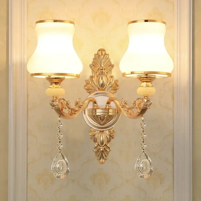 Ornate gold crystal wall sconce with two frosted glass shades and dangling teardrop pendants decorbites crystal wall
