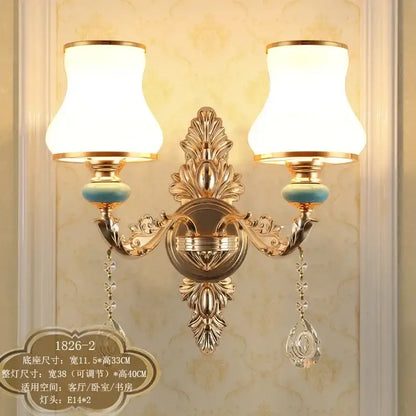 Ornate gold crystal wall sconce with two frosted white lampshades turquoise accents and crystal drops decorbites crystal wall