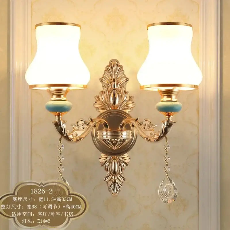 Ornate gold crystal wall sconce with two frosted white lampshades turquoise accents and crystal drops decorbites crystal wall